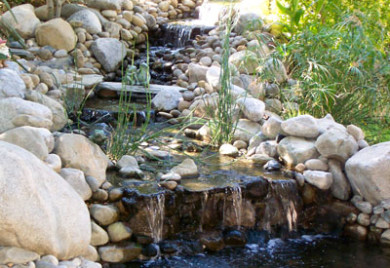 Serene rock garden waterfall pond.