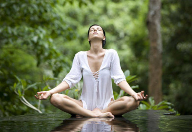 Woman meditating outdoors in nature.